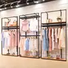 Perchero moderno simple de piso estante multicapa simple estante para ropa de mujer soporte de exhibición de ropa de hierro venta al por mayor
