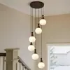 Lámpara de araña larga para escalera de casa autoconstruida, vestíbulo giratorio de planta abierta, sala de estar y comedor de villa, dúplex estilo Zen de vidrio color nogal