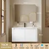 Tocador de baño engrosado y ahorrador de espacio con diseño en color crema, que cuenta con un lavabo redondeado, lavabo cerámico integrado y un lavabo de una sola pieza.