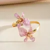 Pulseira de braço torcido com flor gota de óleo estilo metálico europeu e americano, pulseira de pulso única e doce, joia transfronteiriça de nicho de alta qualidade