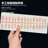 Uñas postizas de alta gama hechas a mano para comercio exterior en rosa nude y blanco con diseños tallados y baño de oro, disponibles para venta al por mayor