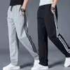 Pantalones deportivos para hombre de cintura elástica para primavera y otoño para el trabajo holgados diarios largos rectos tres rayas pantalones casuales hombre