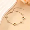 Venta Caliente Transfronteriza Oro 18K Hueco Flor de Trébol de Cuatro Hojas Acero de Titanio Zirconia Conjunto de Collar Pulsera Pendientes para Mujeres Acero Inoxidable