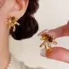 Brincos Maillard Olho de Tigre Dourado para Mulheres, Luxo Leve, Brincos de Alta Qualidade e Elegantes, Brincos Únicos de Nicho Outono e Inverno Atacado
