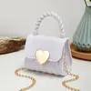 2023 Nuevo bolso mini de gelatina portátil con cierre de corazón en relieve de diamante bolso pequeño casual boca sobre rojo