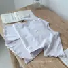 Algodón clase A apto para la piel Conjunto de dos piezas de verano para niños, top de manga corta y shorts, estampado de dibujos animados para bebé, ropa de casa transpirable