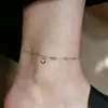 Sin decoloración Estilo nuevo simple tobillera de acero de titanio para niña sensación de alta gama cuerda roja suerte verano moda lujo ligero corazón de amor adornos para el pie