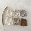 Pantalones cortos de algodón y lino estilo coreano para bebés y niños pequeños Primavera y verano Nuevo suelto transpirable pantalones cortos cortos para niños y niñas