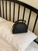 Bolso tejido de lujo ligero de estilo coreano de nicho para mujer, bolso casual tipo concha para el verano 2026, bolso de hombro y cruzado de alta gama