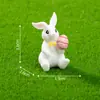 Nuevo producto transfronterizo: Lindo peluche de conejo sosteniendo un huevo de Pascua, accesorios de decoración DIY, mini adornos colgantes