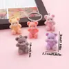 Peluche Oso de Peluche con Colgante de Pajarita de Terciopelo, Llavero Pulsera Bolso Encanto Accesorios de Oso Sentado de Felpa Venta al por Mayor