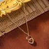 Collar de doble anillo con forma de corazón de alta gama, moderno y único para mujer, cadena para la clavícula de acero de titanio color dorado, joyería que no se decolora
