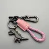 Lindo llavero de dinosaurio de dibujos animados, exquisito llavero para coche de niña, anillo de llavero con cordón de cuero, colgante para mochila