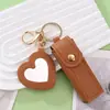 Llavero con caja creativa de cuero PU para guardar labiales, con espejo de maquillaje en forma de corazón y colgante de cubierta protectora para labiales, para Amazon transfronterizo