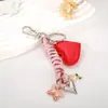 Pingente de Bolsa em Couro Coração Estilo Miu com Corda Trançada Personalizada e Pingente Rosto Sorridente em Liga Metálica Acessório Chaveiro