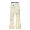 Jeans rotos teñidos de amarillo barro para hombre, desgastados con tinte en spray, arrugados y desgastados, estilo callejero, con botones diagonales únicos y un ligero bootcut.