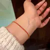 Pulsera de hilo rojo trenzado hecha a mano estilo chino en stock para mujer, diseño clásico de Año Nuevo, año zodiacal 2027, joyería para otoño/invierno al por mayor