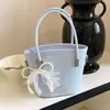 Bolso de mano de moda estilo coreano transfronterizo para mujer, nuevo modelo 2026, bolso de hombro texturizado, bolso cruzado tipo cubo simple y dulce para mujer