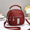 Bolso de mujer 2026 nuevo modelo multibolsillos con cremallera, bolso de mano redondo pequeño, simple y versátil para ir al trabajo, bolso de hombro y cruzado