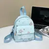 Mochila pequena fofa para mulheres, estilo japonês, perfeita para passeios, com estampas de estrelas e laços, uma pequena bolsa de estudante, uma mini mochila única e casual