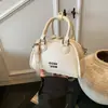 Bolsa de boliche de nicho para mujer, nuevo bolso de mano pequeño de moda 2026, diseño casual versátil, bolso de hombro y cruzado