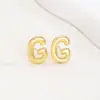 Pendientes de letras de burbuja lisas con baño de cobre y oro real transfronterizos, moda, temperamento, Joker, nuevos pendientes exquisitos, venta al por mayor