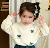Estilo Coreano Meninas 2026 Outono/Inverno Nova Coleção Top de Tricô Branco Off-White com Laço Mini Saia de Veludo Cotelê Azul