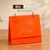 2027 Año de la Oveja: Exquisito juego de regalo de calendario de escritorio estilo chino, personalizado para publicidad corporativa y bancaria, con diseño creativo de calendario y mensual
