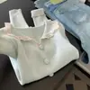 Suéter azul con cuello de muñeca ribeteado de encaje con capa base para mujer, nuevo top de punto de alta gama Otoño e Invierno 2025
