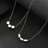 2026 Nuevo Modelo Colgante de Cubo Cuadrado de Acero de Titanio con Logo Grabado Láser Cadena para Clavícula de Acero Inoxidable Estilo Minimalista Unisex