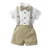 2026 Verano Nuevo Conjunto de Camisa de Algodón de Manga Corta de Color Sólido para Niños con Pajarita y Tirantes Estilo Coreano Traje para Niños Lote Caliente