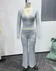Conjunto de 2 piezas para 2026: top deportivo cruzado europeo y americano de chica popular, escote en V profundo, manga larga corta y pantalones de yoga acampanados de cintura alta