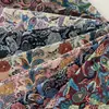 Producción en fábrica y venta al por mayor de tela jacquard teñida en hilo, jacquard de estilo étnico, cola de fénix, tela de poliéster y algodón de alta densidad.