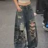 Pantalones vaqueros retro americanos desgastados con salpicaduras de tinta y detalles rotos, nuevo estilo primavera/otoño para mujer, con un estampado de letras de moda y un diseño de longitud hasta el suelo