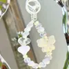 Corrente de celular com contas de borboleta UV criativa pequena e fresca, chaveiro fofo de amor, pingente de bolsa pequeno, material para pingente