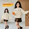 Conjunto de Suéter Jacquard Elegante com Laço e Gola Redonda e Saia de Lã para Meninas 2026 Novo Estiloso Fashionable Tricô Tendência