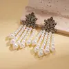 Pendientes de borla de flor de concha blanca transfronterizos europeos y americanos con perlas, pendientes de estilo de corte francés, pendientes ligeros y lujosos con un toque de alta gama