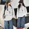 Camiseta base de algodón puro para niña 2026 nuevo modelo camiseta de dibujos animados de manga larga con cuello redondo para niños top de otoño