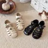 Sandalias Romanas Cerradas de Flor de Camelia de Moda para Niñas 2026 Verano Nuevas Sandalias de Princesa para Niños Zapatos de Playa para Bebé