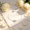 Collar y pulsera románticos y a la moda de estilo francés de acero de titanio con doble corazón y diseño de anillos entrelazados, accesorio único y versátil para el día a día.