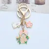 Llavero de Conejo con Flor de Cerezo Estilo Japonés para Mujer, Lindo Aro de Conejito, Cubierta para Auriculares, Colgante para Bolso, Pequeño Regalo para Mejores Amigas