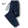 Pantalones de chándal holgados de pierna recta para hombre, talla grande, para primavera y otoño, joggers modernos con bolsillo y cremallera, pantalones casuales elegantes para hombre