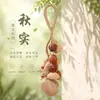 Campanilla de mano con forma de cáscara de fruta indonesia de planta natural, colgante para bolso, instrumento de terapia de sonido curativo, carillón de viento, adorno para colgar en el coche, llavero