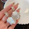 Aretes de flor de concha con borla, diseño nicho, aretes de alta gama, aretes populares nuevos para mujer, verano 2023, aretes