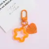 Llavero con hebilla de puerta giratoria, colgante de pentagrama y corazón transparente de colores, accesorio hecho a mano para bolsos