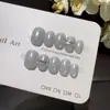 Uñas Postizas Hechas a Mano Glimmering LightClear Azul Nebuloso con Base Perlada Hielo-Translúcida y Diseño Largo de Puntos Blancos Sencillos