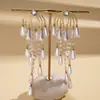 Pendientes de borla de flor de concha blanca transfronterizos europeos y americanos con perlas, pendientes de estilo de corte francés, pendientes ligeros y lujosos con un toque de alta gama