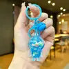 Llavero creativo de astronauta acrílico relleno de aceite, colgante de botella de arena líquida de astronauta, decoración linda, regalo pequeño al por mayor