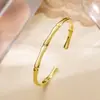 Pulsera Abierta de Cobre Chapado en Oro de 18 Quilates con Diseño de Bambú Retorcido, Moda Transfronteriza de Alta Venta, Personalidad, Versátil, Nicho para Mujer