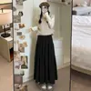 Saia feminina de tricô macia e confortável 2026 primavera e outono, de corte A soltinho estilo bolo, saia casual e que afina, de comprimento médio